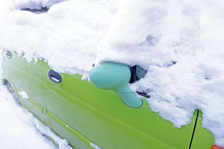 a car in the snow. car mirror close-up in the snowの写真素材