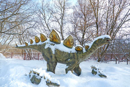 Stegosaurus in the snow. Dinosaurs by nature believe sizes as they were when they were aliveの写真素材