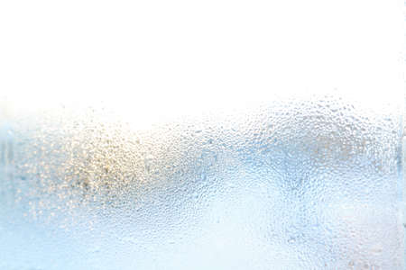colorful dew drops on the glass, light background