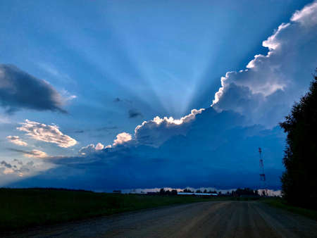 The rays of the evening setting sun. The sun's rays make their way through the clouds.の写真素材