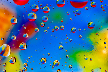 Abstract colorful background of oil circles. Oil in the water surface circles, water foam and oil bubbles.の写真素材