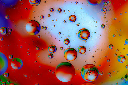 Abstract colorful background of oil circles. Oil in the water surface circles, water foam and oil bubbles.の写真素材
