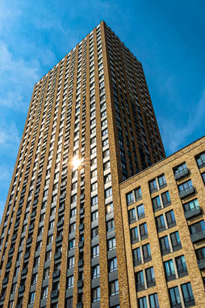 View of a multi-apartment residential complex of a new building against a background of blue sky. High quality photoの写真素材
