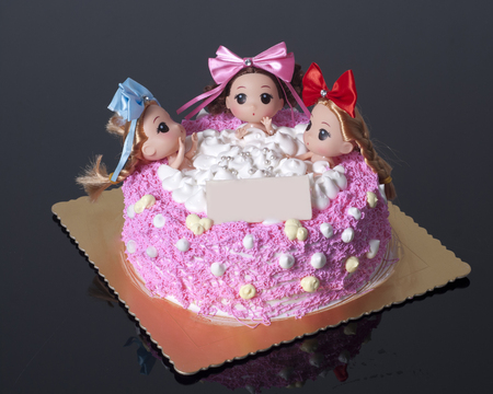 A Creative Cake with three girls sitting in bathtub. の写真素材