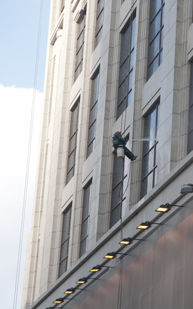 A worker is washing the building located in shanghaiのeditorial素材