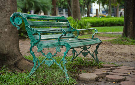 A bench at the rearmost of the Chatuchak Park, Bangkok, Thailand. There is pushing up a reminiscent of loneliness even the park is situated in the one of busiest area of city.の写真素材