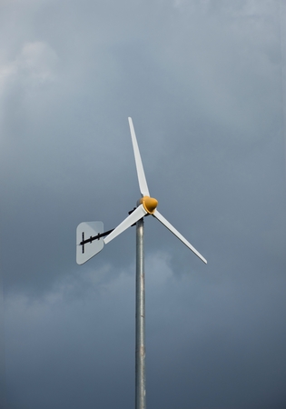 A formidably wind turbine waiting for upcoming storm with its bravery heart in the park.の写真素材
