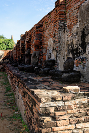 Another headless Buddha statues sitting on the pedestal in the backside of Wat Mahathat. The reflection of ritual, pray and meditation.の写真素材