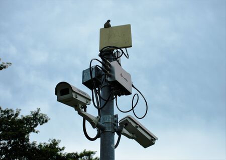 Field surveillance camera network in the public park with with its mighty friend at the top. image capture from the rod-fai park,  Chatuchak, Bangkok from late 2017.のeditorial素材
