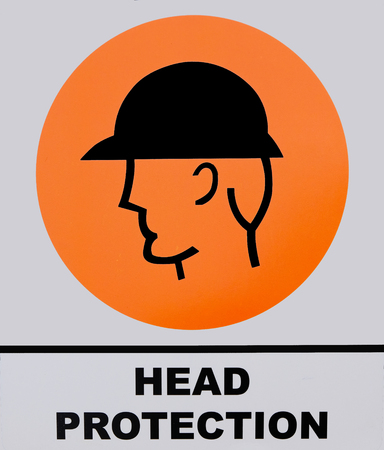 Head protection sign on white and orange background. This photo was taken from the sign board, it is not an illustration work.の写真素材