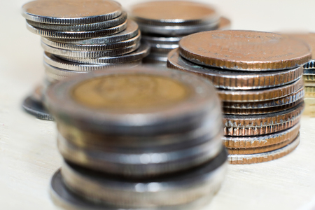 Serveral coin stacks on white background. Focus on the background stacks.の写真素材