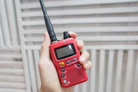 A hand holding red Walkie-Talkie.の写真素材