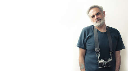 Man in his 40s posing with the film camera - copy space. High quality photo