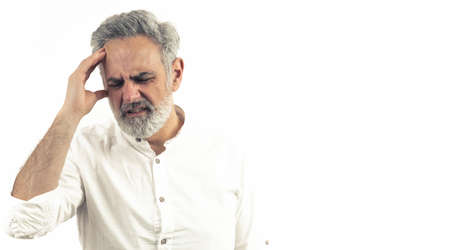 Middle aged man struggling from migreine - headache - studio shot isolated on white background. High quality photoの写真素材
