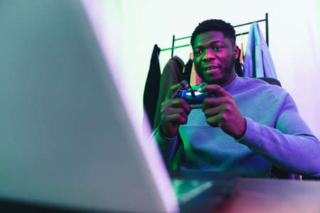 Afroamerican man playing video game console - medium shot. High quality photoの写真素材