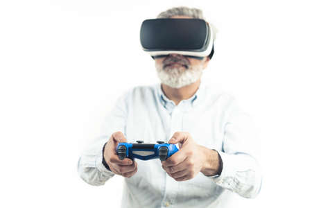 Middle-aged man wearing Virtual Reality set - VR goggles. Isolated on white. High quality photoの写真素材