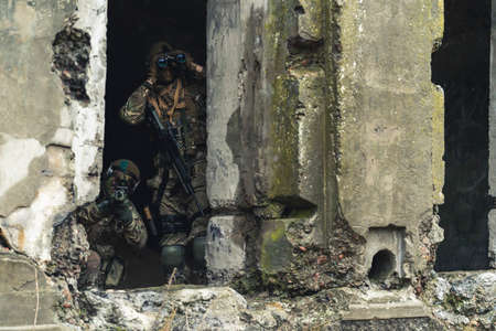 Scanning destructed building for rebel group threats. High quality photoの写真素材