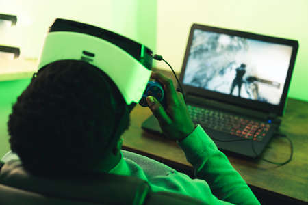 Black man paying on computer VR headset game pad - portrait. High quality photoの写真素材