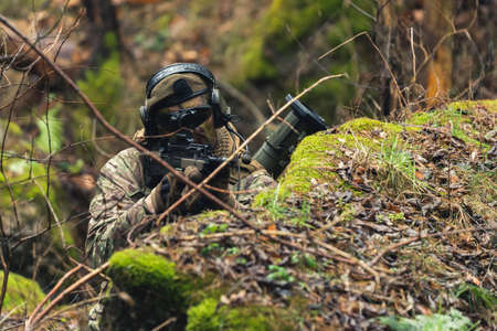 Eagle like precise aim rifle camouflaged in the woods. High quality photoの写真素材