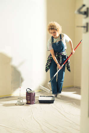 Crafty girl painting her room - moving into new flat DIY. High quality photoの写真素材
