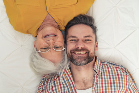 portrait of shared happiness between middle-aged caucasian gentleman and his pensioner mother . High quality photoの写真素材