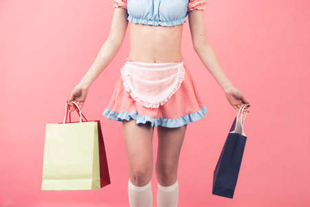 Costume player holding the gift bags on pink background - mid body. High quality photoの写真素材