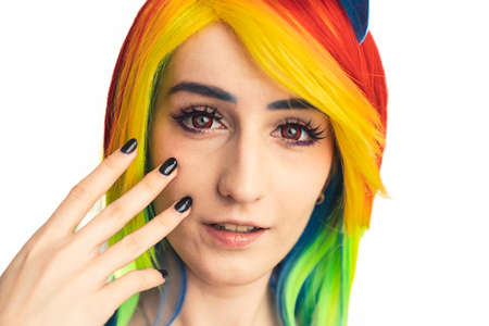 Pretty rainbow-haired caucasian woman playing with her lips and dallying white background close-up shotの写真素材