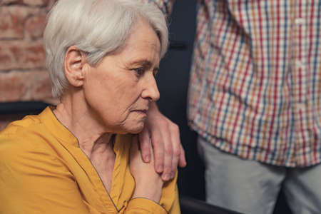 miserable grey-haired retired elderly lady Pink October . High quality photoの写真素材