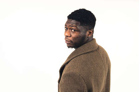 African American gentleman looking back at the camera white background - close-up shot. High-quality photoの写真素材