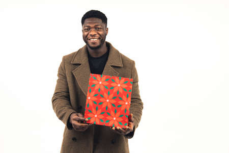 happy man of color handing present white background - portrait shot. High quality photoの写真素材