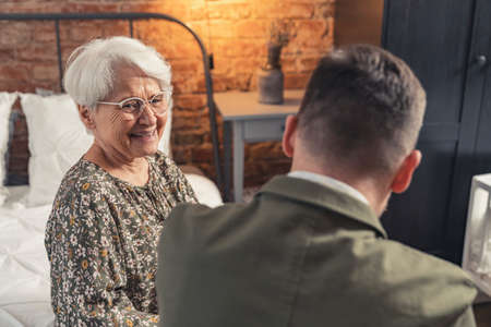 friendship between generations grandmother and middle-aged grandson grinning and laughing. High quality photoの写真素材