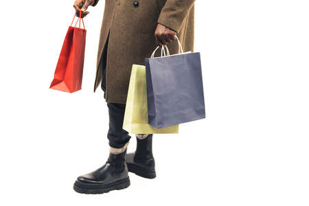 brown guy doing shopping focus on the bags white background - close-up shot. High quality photoの写真素材