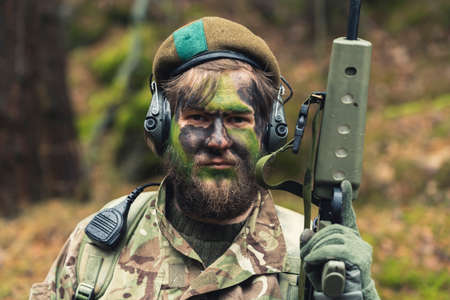 Adamant unshaven hot blooded soldier proudly posing . High quality photoの写真素材