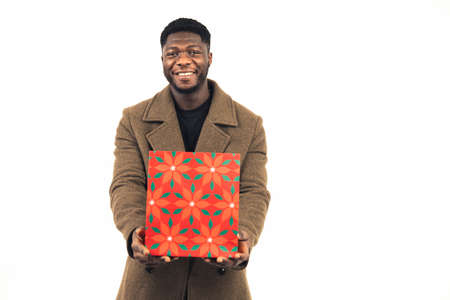 cheerful man offering gift white background - portrait shot. High-quality photoの写真素材