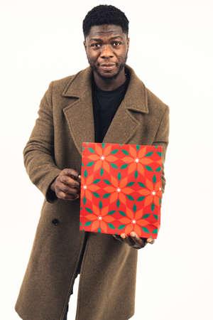 African American man bringing a present white background - full shot. High-quality photoの写真素材