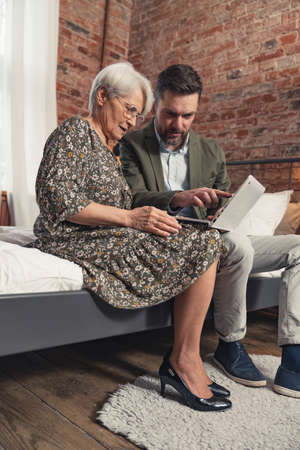 vertical photo of elegantly dressed caucasian entrepreneurs working together on a project. High quality photoの写真素材