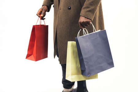 carrying shopping paper bags white background - close-up shot. High-quality photoの写真素材