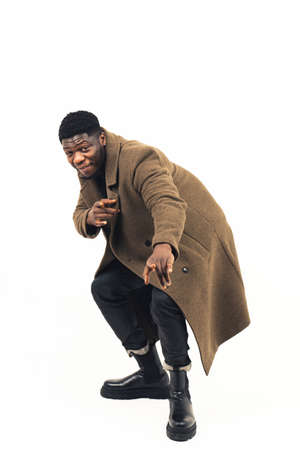 African American having fun modeling pointing at the camera white background - full shot. High-quality photoの写真素材