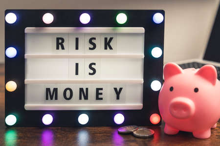 Risk is money motivational phrase on marquee lightbox - self development business concept. High quality photoの写真素材