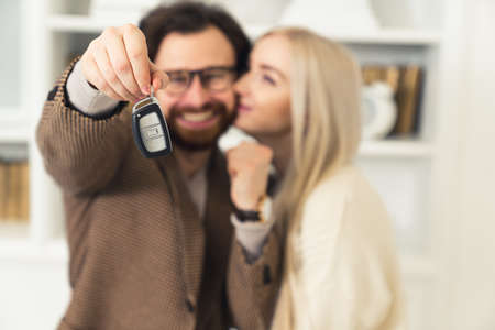 millennial european couple succeeded in getting a loan and bought their first car . High quality photoの写真素材