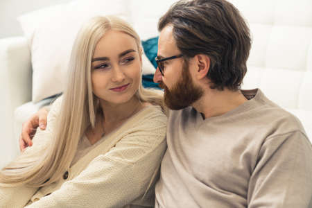 attractive caucasian long-haired blonde woman in her late 20s flirtatiously looking at her good-looking boyfriend. High quality photoの写真素材