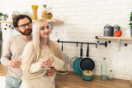 cute caucasian millennial couple celebrating womens day or new eves by cuddling and drinking expensive alcohol. High quality photoの写真素材