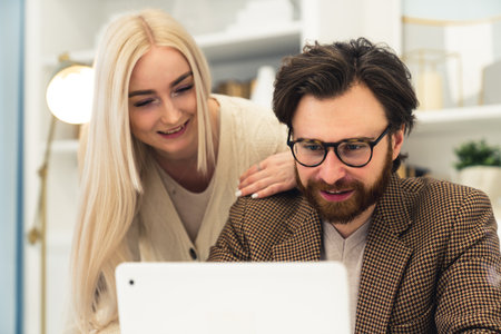 Business caucasian people working together on a project, blonde long-haired woman and her brunet partner . High quality photoの写真素材