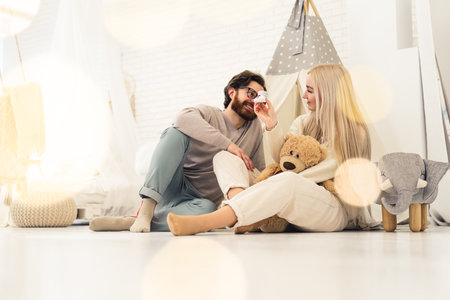 married caucasian soon-to-be-parents couple sitting in their future newborns room and chatting about parenthood. High quality photoの写真素材