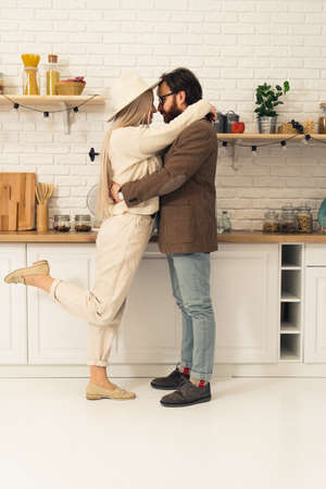 European millennial couple embracing each other in an intimate hug and celebrating moving in together vertical shot. High quality photoの写真素材