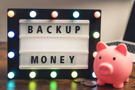 Backup money phrase spelled on marquee lightbox - savings concept. High quality photoの写真素材