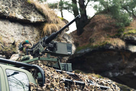 Rugged military grade machine gun mounted on truck unit . High quality photo