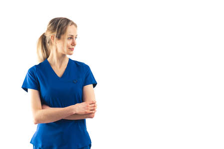 Proud caucasian nurse wearing blue uniform over white background. Copy space medium studio shot. High quality photoの写真素材