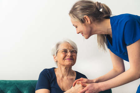 Caucasian woman having a friendly conversation, diligent nurse and senior resident patient. Happy retirement concept. High quality photoの写真素材