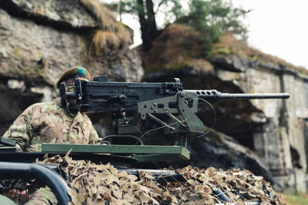 Fireaim using a heavy machinery rifle mounted weapon for military purpose. High quality photoの写真素材
